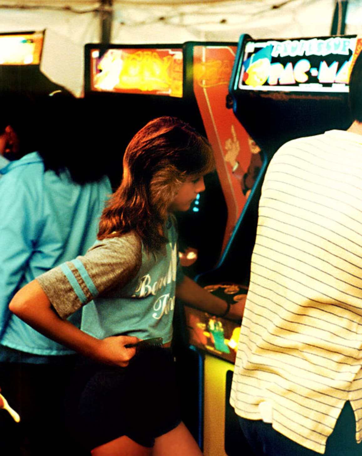 “Girl playing Pac-Man at the arcade in 1983.”